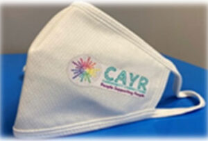 A COVID Facemask with a CAYR logo embroidered on it.